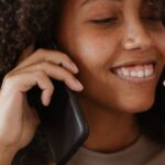 Smartphone - A Woman Wearing a Brown Sweater on a Phone Call