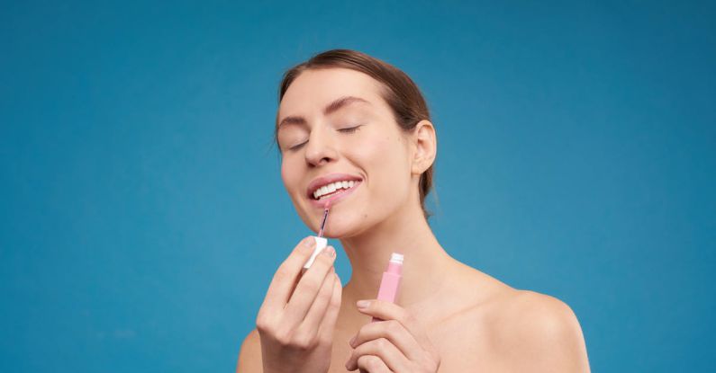 Makeup - Woman Applying Lipstick