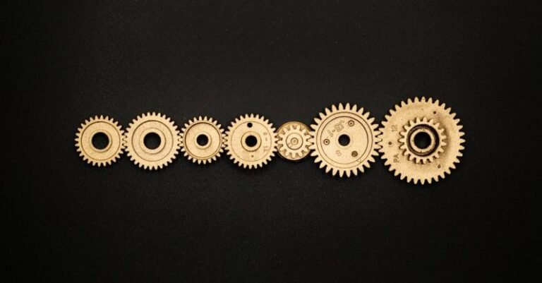 Progress - Photo of Golden Cogwheel on Black Background