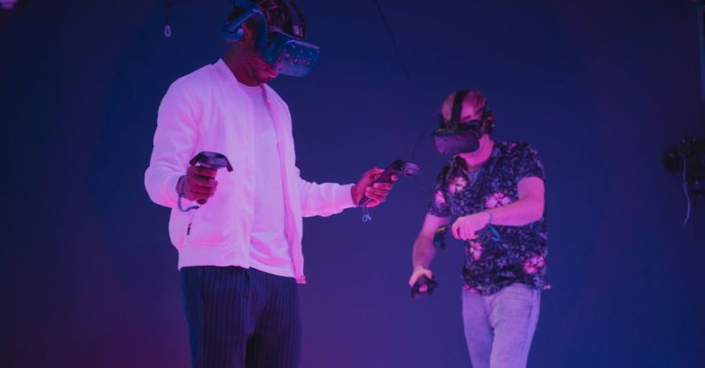 Consoles - Men Wearing VR Headsets Looking Down