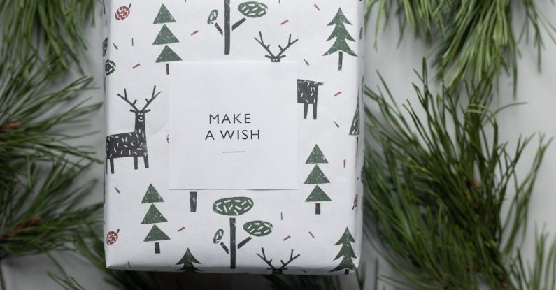 Gift - Wrapped New Year present box placed among coniferous branches